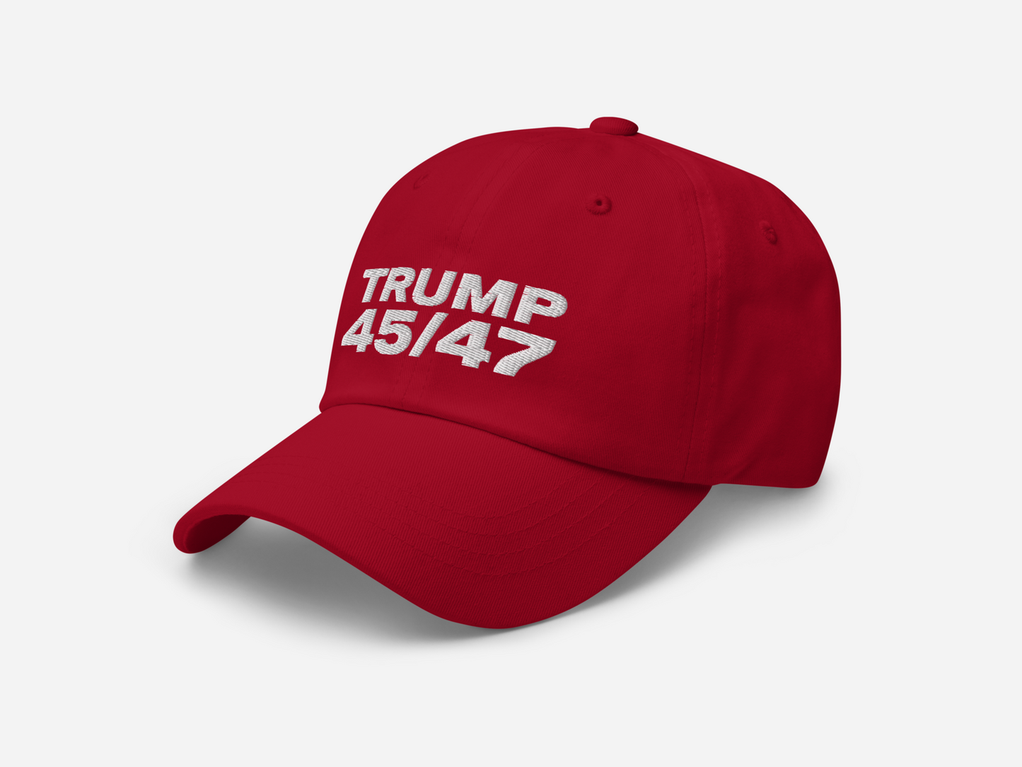 red dad hat featuring '45/47' embroidered in bold white text, shown at a left-angled front view on a white background